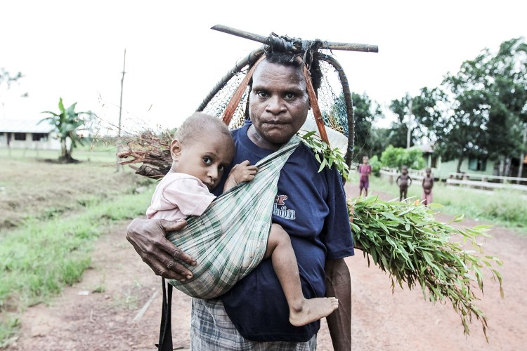 Marind man and child in Merauke by Nanang Sujana